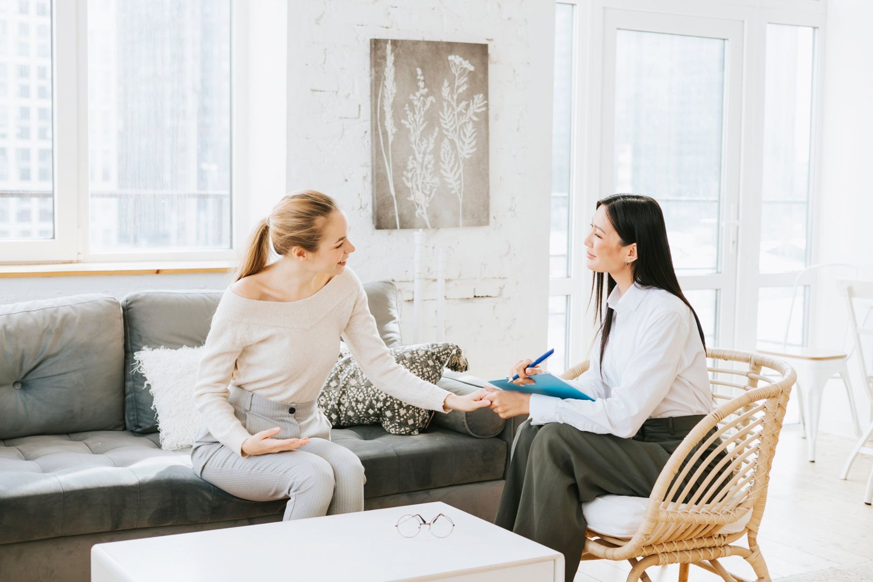 A therapist meeting with a patient in a bright office